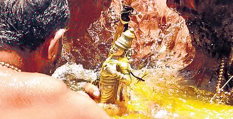 Tantri Kandararu Mahesh Mohanaru performing the ‘aarattu’ ceremony in the Pampa river opposite to Ganapathy temple on Wednesday  
