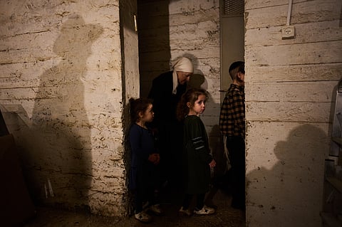 People take cover in a bomb shelter as air raid sirens warn of incoming Iranian missile strikes in Bnei Brak, Israel, Wednesday, April 1, 2026. 