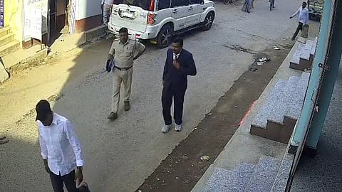 CCTV footage shows two 'officers' outside the jewellery shop in Dhanwar.