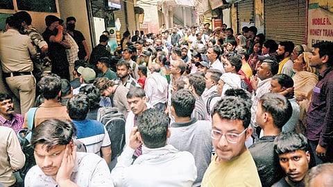 People queue to refill their empty LPG cylinders near a gas agency at Vasant Kunj in New Delhi on Wednesday amid the ongoing gas crisis.