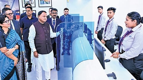 CM Mohan Charan Majhi interacting with the staff at the visa application centre