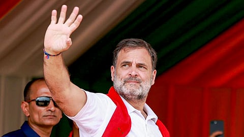 LoP in the Lok Sabha and Congress leader Rahul Gandhi waves to a gathering during a public meeting, in Assam.