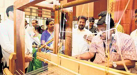 Chief Minister A Revanth Reddy watches a weaver at work during the inauguration of ATEXCON 2026 at Hitex in Hyderabad on Friday