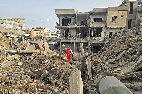 A rescue worker inspects the debris of destroyed buildings at the site of an Israeli strike in the southern Lebanese area of Maarakeh near the coastal city of Tyre on April 4, 2026.