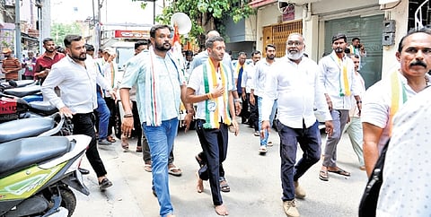 Congress candidate for Davanagere South Samarth Shamanur walks barefoot while campaigning in the city 
