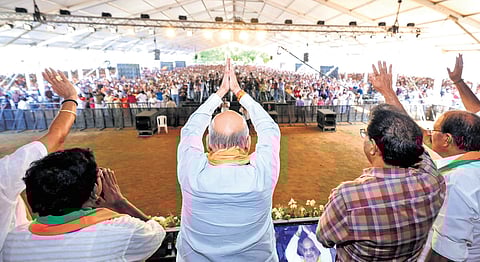 Union Home Minister Amit Shah greets the audience at the election convention of the Twenty20 candidate for Kunnathunad at Kolencherry on Sunday