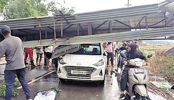 The car trapped under the welcome arch that fell during nor’wester in Athagarh 