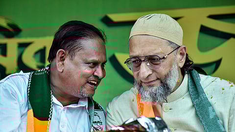 AIMIM President and MP Asaduddin Owaisi, right, in conversation with Aam Janata Unnayan Party (JUP) chief and candidate for Nowda constituency, Humayun Kabir, during a public rally in support of the candidate ahead of the West Bengal Assembly Election, in Murshidabad district, Wednesday, April 1, 2026. 