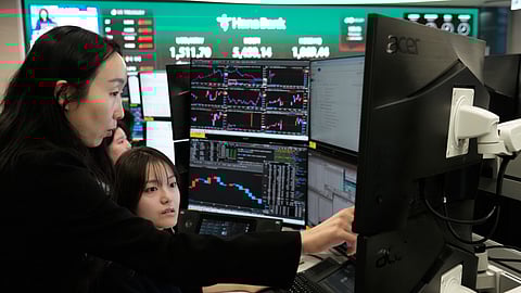 Currency traders watch monitors at the foreign exchange dealing room of the Hana Bank headquarters in Seoul, South Korea, Monday, April 6, 2026.