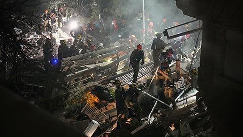 Israeli security forces and rescue teams work amid the rubble of a residential building struck by an Iranian missile in Haifa, Israel, Sunday, April 5, 2026. 