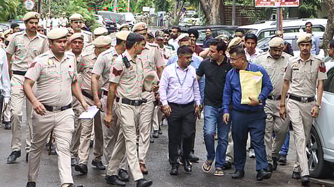 An Assam Police team and others leave the Delhi residence of Congress leader Pawan Khera after questioning in connection with a case linked to allegations made against Assam Chief Minister Himanta Biswa Sarma and his family, in New Delhi, Tuesday, April 7, 2026.