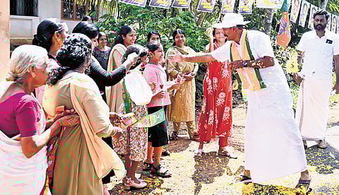 NDA candidate Shone George greeting voters