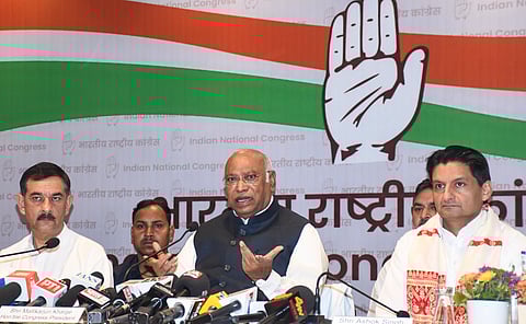 Congress President and Rajya Sabha Leader of Opposition Mallikarjun Kharge, centre, addresses a press conference ahead of the Assam Legislative Assembly Election, in Guwahati, Assam, Tuesday, April 7, 2026.
