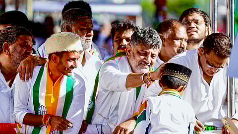 Karnataka Deputy Chief Minister DK Shivakumar, front left, during an election campaign in support of Congress candidate from the Davanagere South constituency, Samarth Shamanur, front right, ahead of Davangere bypolls.