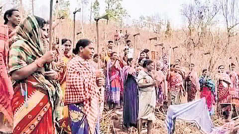 Villagers armed with traditional weapons stand guard at Sijimali on Wednesday