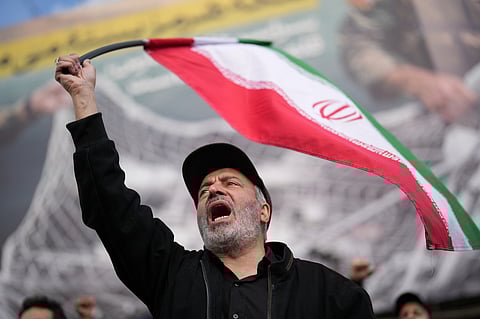 A government supporter chants slogans during a gathering after the announcement of a two-week ceasefire with the United States and Israel in Tehran, Iran, Wednesday, April 8, 2026.