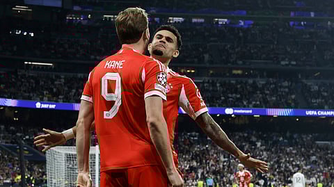 Bayern Munich's Harry Kane celebrates scoring his team's second goal with Luis Diaz during the UEFA Champions League quarter final first leg football match between Real Madrid CF and FC Bayern Munich on April 7, 2026.