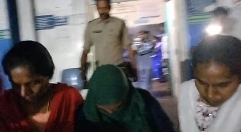 The accused was identified as T. Jyothi, being taken by the police.