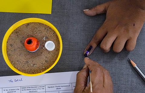  A voter gets her finger marked with indelible ink while casting vote during the Puducherry Assembly elections, at a polling station in Puducherry, Thursday, April 9, 2026.