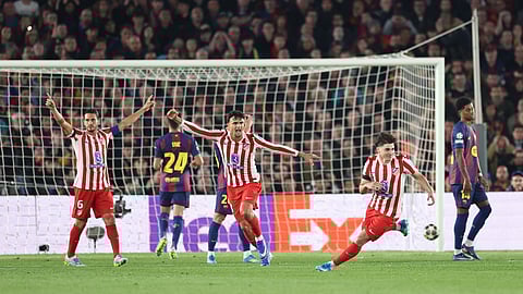Atletico Madrid's Julian Alvarez (R) celebrates scoring his team's first goal during the UEFA Champions League quarter final first leg football match between FC Barcelona and Club Atletico de Madrid on April 8, 2026.