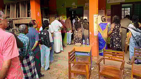 Voters queue up to cast their votes at Government High School, Kachani, in Vattiyoorkavu constituency, Thiruvananthapuram, during the first hour of polling in the Assembly elections on Thursday.