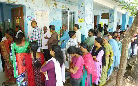 People queueing up in front of a polling booth at St. Francis UP School in Pizhala