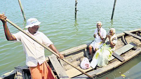 Bhaskaran and Thankamani, an elderly couple from Thanthonnithuruth island near Kochi, return after voting at a polling booth in Pachalam on Thursday.