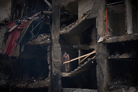 A man checks a destroyed building, that was struck in an Israeli airstrike on Wednesday, in Beirut, Lebanon, Friday, April 10, 2026.
