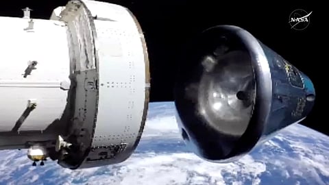 In this image from video provided by NASA, the Artemis II Orion capsule, right, separates from the service module above the Earth in preparation for splash down in the Pacific Ocean, on Friday, April 10, 2026.
