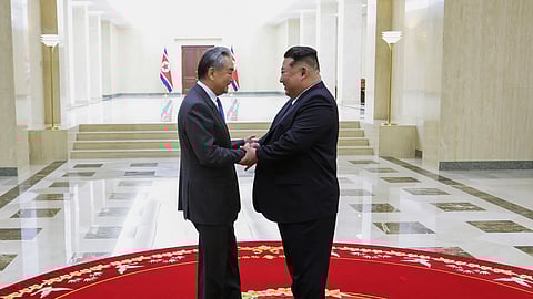 In this photo provided by the North Korean government, leader Kim Jong Un, right, meets Chinese Foreign Minister Wang Yi in Pyongyang, North Korea, Friday, April 10, 2026.