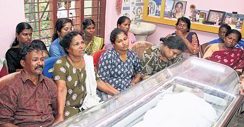 Nithin Raj’s father Rajan, mother Latha, and sisters Nikita and Rakhi sitting beside his mortal remains at their residence in Puthukulangara near Nedumangad in Thiruvananthapuram on Sunday 