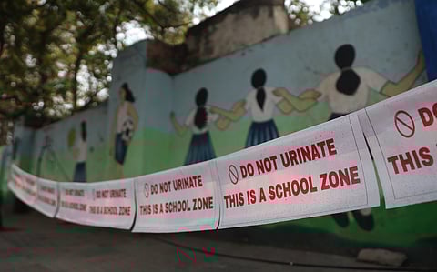 Do not Urinate warning signs put up at a footpath near Aliya School at Gun Foundry in Hyderabad on Friday.