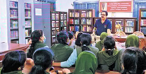 Former school librarian M A Rahman interacting with students