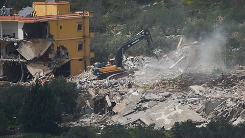 Israeli bulldozers demolish homes in southern Lebanon, as seen from northern Israel, Sunday, April 12, 2026.