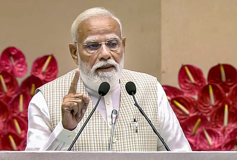 Prime Minister Narendra Modi gives an address during the 'Nari Shakti Vandan Sammelan', at Vigyan Bhawan, in New Delhi. 