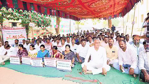 BRS leader T Harish Rao participates in a dharna staged by electricity employees, demanding resolution of their long-standing issues, in Siddipet on Monday.