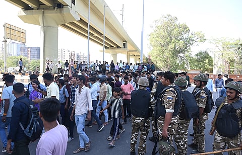 Factory workers during a protest demanding a hike in wages, in Noida, Gautam Buddh Nagar district near Metro Station NSEZ Uttar Pradesh, Monday, April 13, 2026.