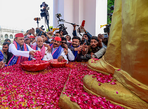 Samajwadi Party chief Akhilesh Yadav, left, pays floral tribute to the statue of Dr BR Ambedkar on the occasion of the latter's birth anniversary in Lucknow.