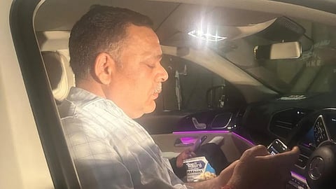 A screengrab of the accused individual sitting inside the car.