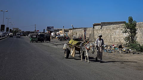 A Sudanese man pulls a donkey cart filled with water for sale in Port Sudan on April 14, 2026.