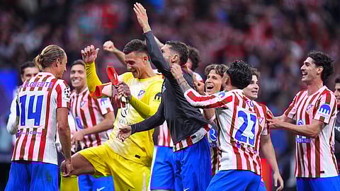 Atletico Madrid's players celebrate at the end of the Champions League quarterfinal second leg soccer match between Atletico Madrid and Barcelona in Madrid, Spain, Tuesday, April 14, 2026.