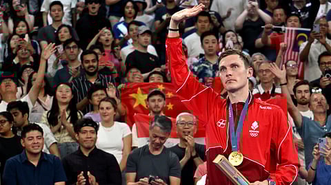 Denmark's gold medallist Viktor Axelsen celebrates with his medal at the men's singles badminton medal ceremony during the Paris 2024 Olympic Games at Porte de la Chapelle Arena in Paris on August 5, 2024.
