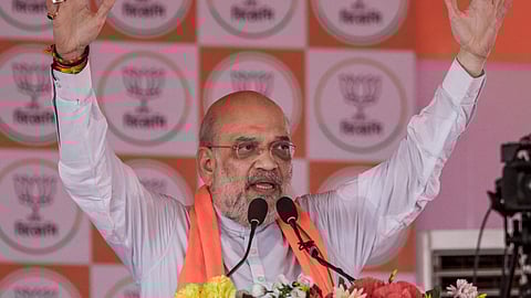 Union Home Minister Amit Shah addresses the gathering during a public meeting in support of BJP candidates ahead of the West Bengal Assembly elections, at Gochiar in Dakshin Dinajpur, Tuesday, April 14, 2026.
