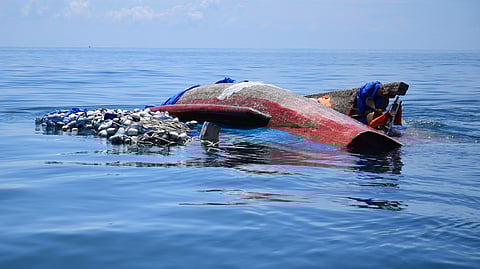 A capsized boat carrying Rohingya refugees drifts in the Andaman Sea.