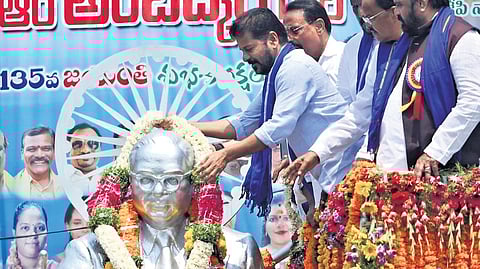 Chief Minister A Revanth Reddy garlands a statue of Dr BR Ambedkar on his 135th birth anniversary, at Lower Tank Bund in Hyderabad.