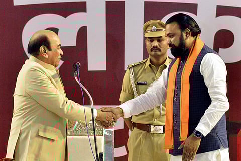 Governor Syed Ata Hasnain, left, congratulates BJP leader Samrat Choudhary after administering the oath of office to the latter during his swearing-in ceremony as the new Chief Minister, in Patna, Wednesday, April 15, 2026.