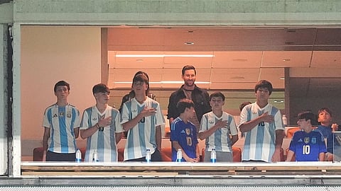 Argentina forward Lionel Messi, center top, watches from a box with family and friends at the start of an international friendly soccer match between Venezuela and Argentina, Oct. 10, 2025, in Miami Gardens, Fla.