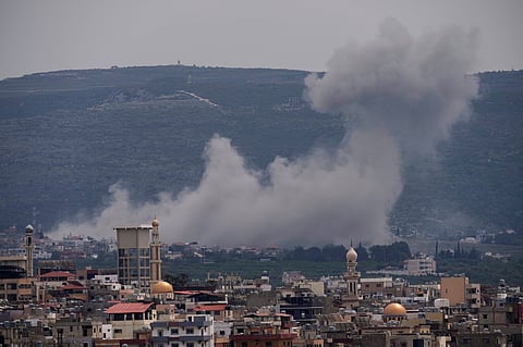 Smoke rises following an Israeli airstrike on the village of Qlaileh, as seen from the southern port city of Tyre, Lebanon, Wednesday, April 15, 2026.