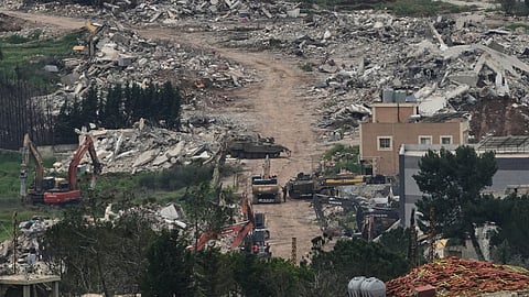 Israeli army vehicles and bulldozers operate in southern Lebanon, as seen from northern Israel, Wednesday, April 15, 2026.