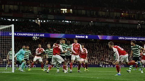 Arsenal's Leandro Trossard (R) shoots but fails to score during the UEFA Champions League quarter-final, second-leg football match between Arsenal and Sporting Lisbon at the Emirates Stadium in north London on April 15, 2026. 
